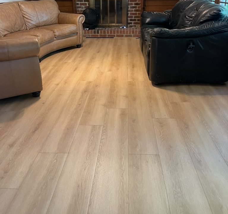 After: Living room: carpet replaced with plank flooring